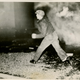 Worker ignores tear gas, throws rocks at police as he enters Fisher #1 to relieve sit-down strikers on Jan. 2, 1937